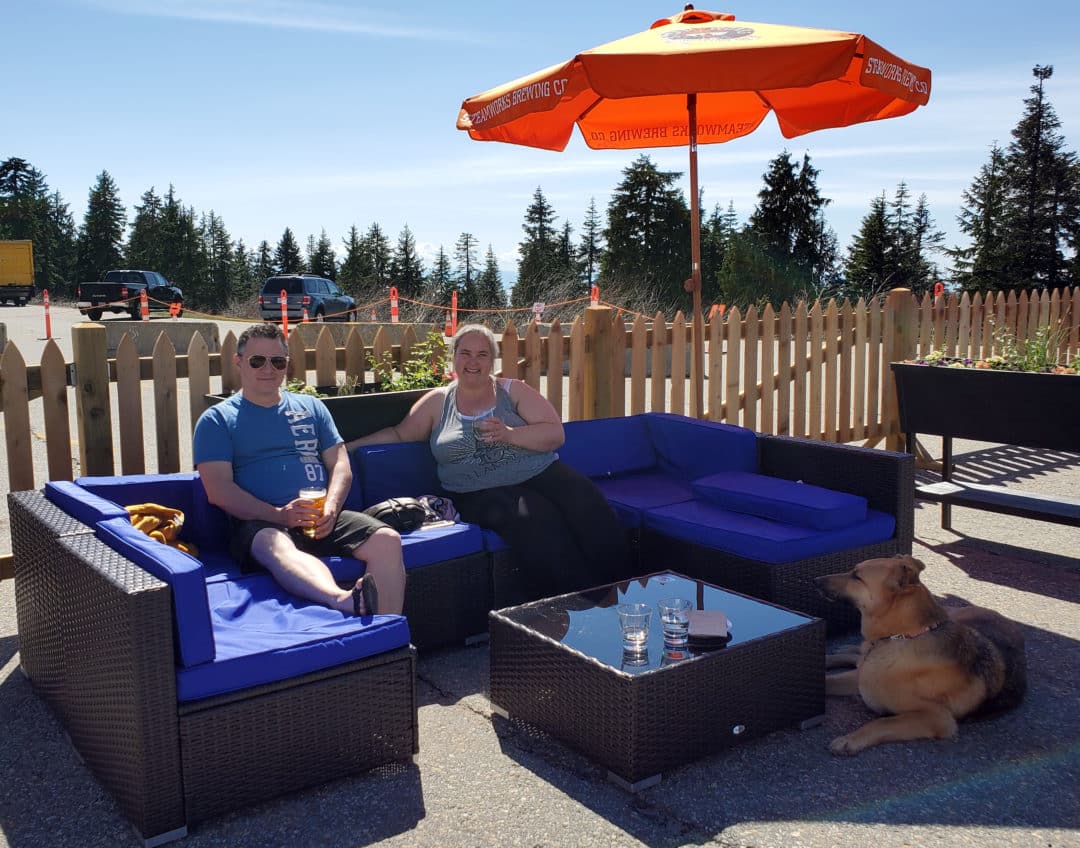 The dog network founders and their dog, avy, enjoying a cold beverage on a hot sunny day at the dog-friendly outdoor patio at the rock chute kitchen and bar patio on mount seymour, north vancouver, bc