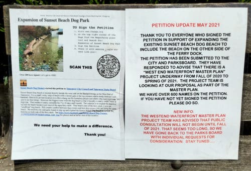 A picture of a sign about a petition to expand sunset beach dog park on a park bench at stanley park off-leash dog park, vancouver, bc