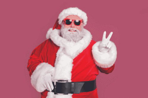 A picture of santa wearing sunglasses and giving a peace sign.