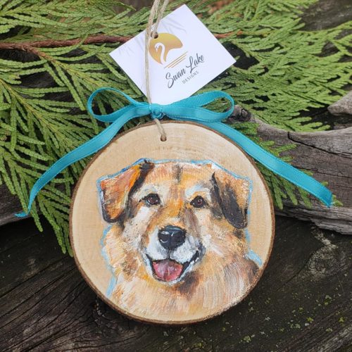A picture of a dog on a wooden ornament