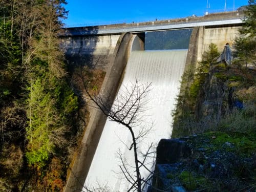 A majestic view of the water falling over the dam on a beautiful sunny day at capilano regional park