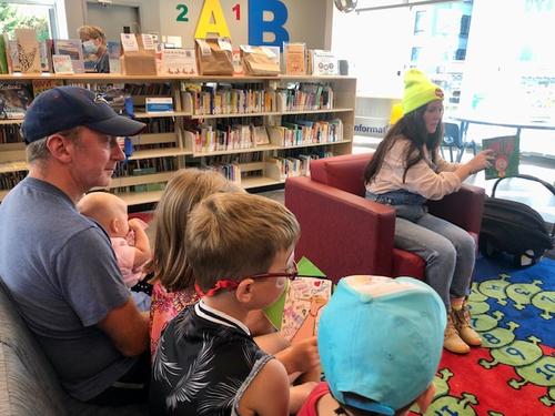 Lindsay reading her books to children at a public library.